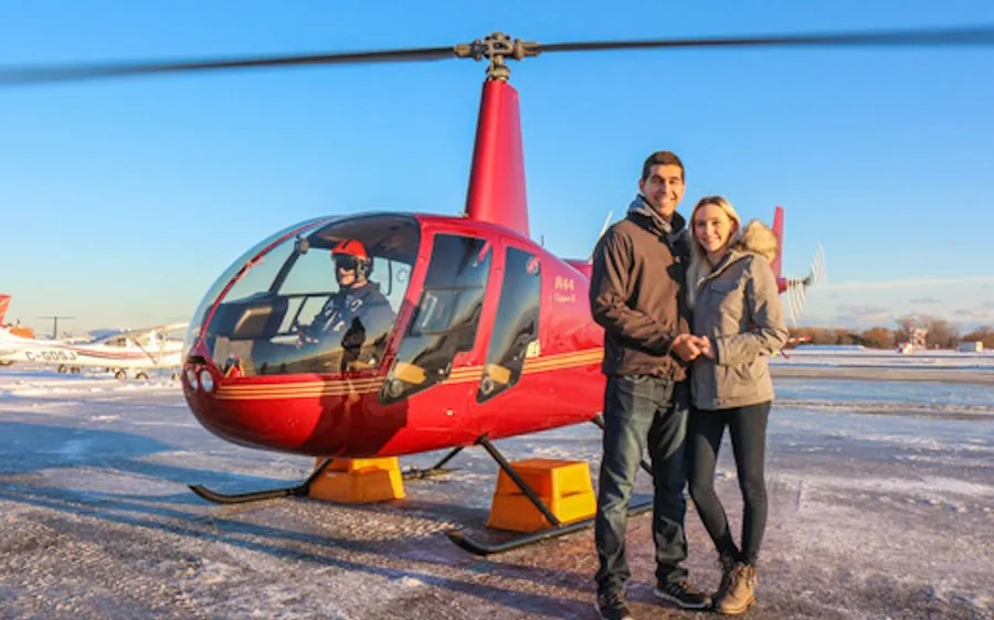 Ein roter Hubschrauber am Ufer des Ontariosees mit der Skyline im Hintergrund